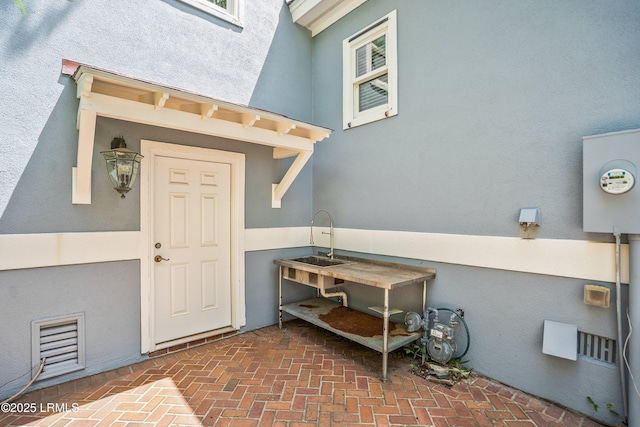5 Petigru Dr, Beaufort, SC 29902 - entrance to property with stucco siding and a sink