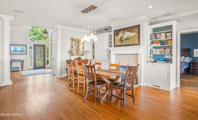 5 Petigru Dr, Beaufort, SC 29902 - dining area featuring decorative columns, light wood-style floors, ornamental molding, built in shelves, and recessed lighting