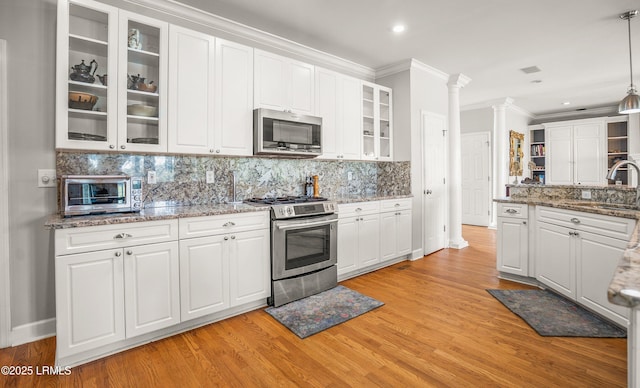 5 Petigru Dr, Beaufort, SC 29902 - kitchen with appliances with stainless steel finishes, crown molding, white cabinetry, and recessed lighting