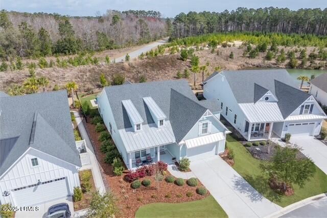 birds eye view of property with a forest view