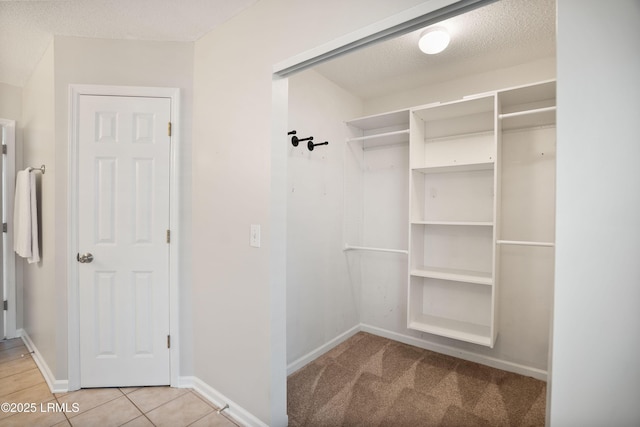 walk in closet featuring tile patterned flooring