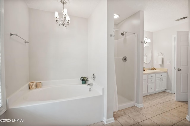 bathroom with vanity, plus walk in shower, tile patterned flooring, and a textured ceiling