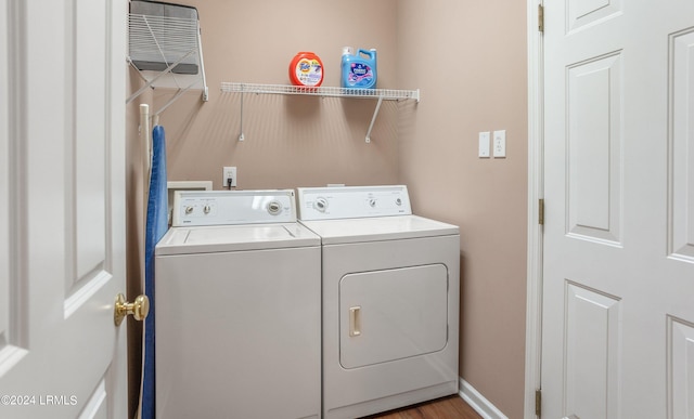 washroom featuring light wood-type flooring and washer and clothes dryer