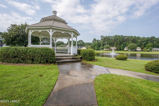 view of property's community featuring a water view, a yard, and a gazebo