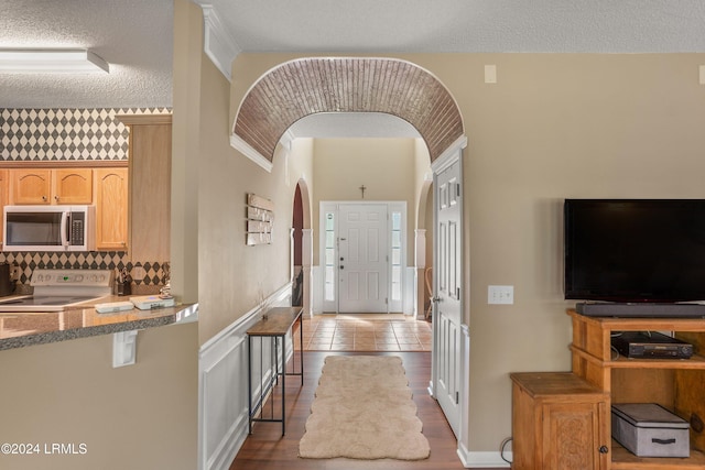 entrance foyer featuring a textured ceiling and light hardwood / wood-style flooring