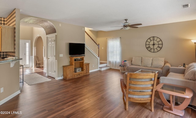 living room featuring ceiling fan and dark hardwood / wood-style flooring