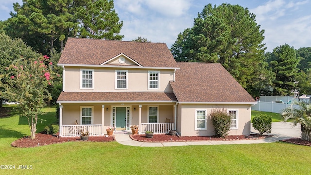 view of front of home featuring covered porch and a front yard