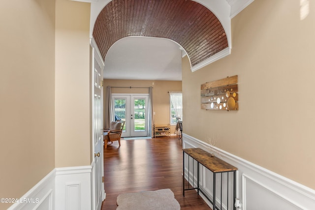 hall featuring french doors, crown molding, and dark wood-type flooring