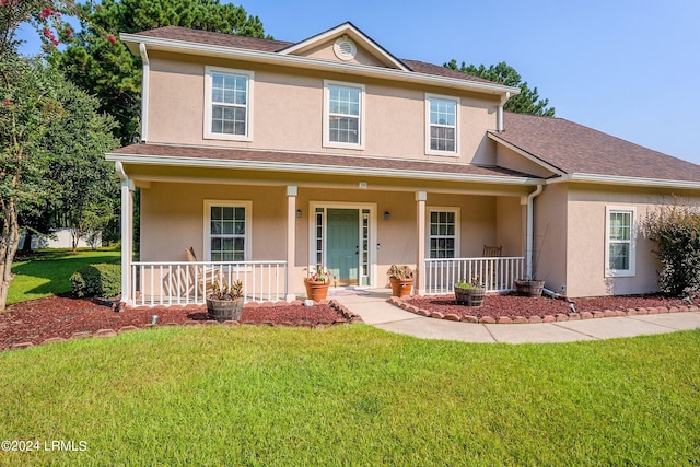 view of front property with a front lawn and a porch