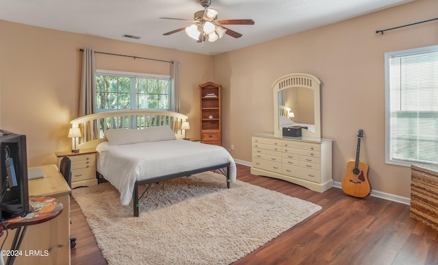 bedroom with ceiling fan and dark hardwood / wood-style floors