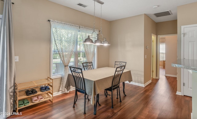 dining space featuring dark hardwood / wood-style floors and a healthy amount of sunlight