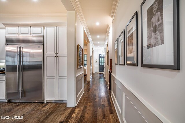 hallway featuring dark wood-type flooring and ornamental molding