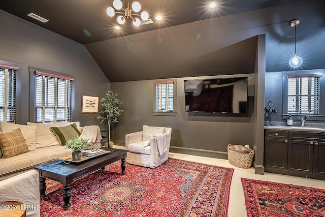 living room featuring vaulted ceiling, sink, and a notable chandelier