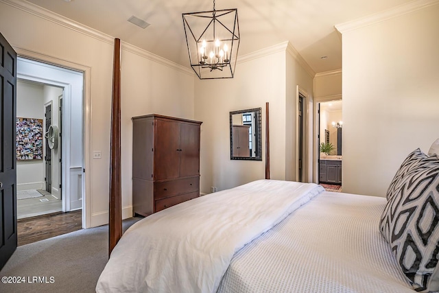 carpeted bedroom featuring crown molding, connected bathroom, and an inviting chandelier