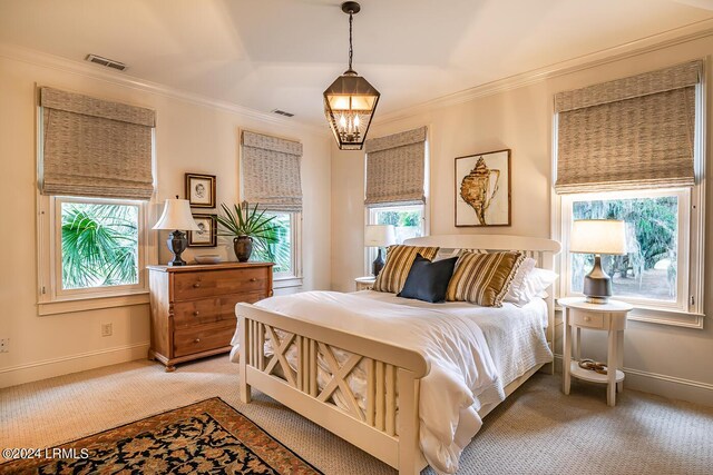 bedroom featuring crown molding, carpet floors, and a chandelier