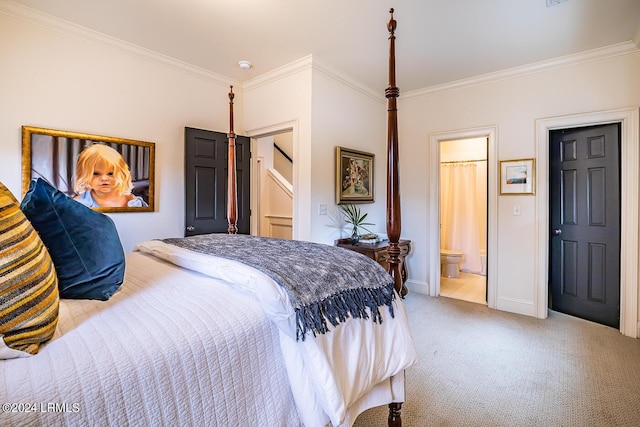 bedroom with crown molding, ensuite bath, and light carpet