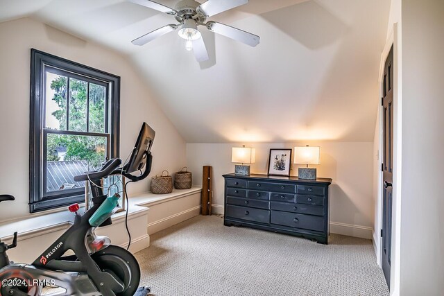 workout room featuring lofted ceiling, light carpet, and ceiling fan