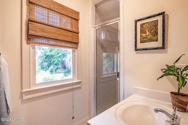 bathroom with vanity and a shower with shower door