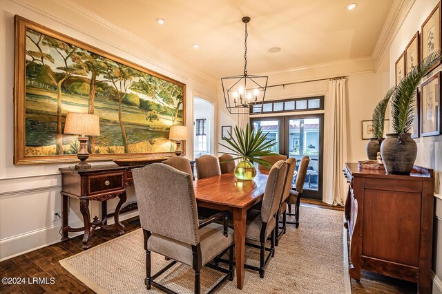 dining space featuring crown molding, wood-type flooring, french doors, and a notable chandelier