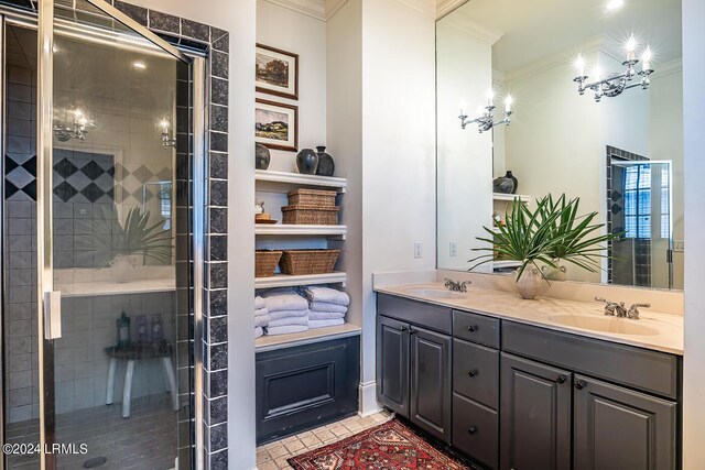 bathroom with tile patterned floors, ornamental molding, a shower with shower door, and vanity