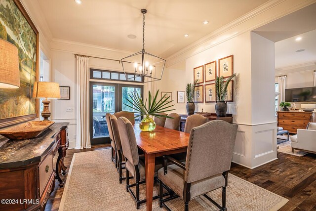 dining room with crown molding, an inviting chandelier, and dark hardwood / wood-style flooring