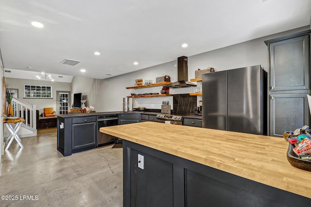 610 E Ave, Bluffton, SC 29910 - kitchen featuring visible vents, a peninsula, stainless steel appliances, wood counters, and exhaust hood
