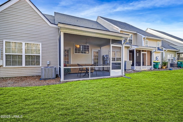 610 E Ave, Bluffton, SC 29910 - rear view of house with a yard, cooling unit, and a sunroom