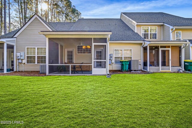 610 E Ave, Bluffton, SC 29910 - rear view of property with central air condition unit, a lawn, a sunroom, and roof with shingles