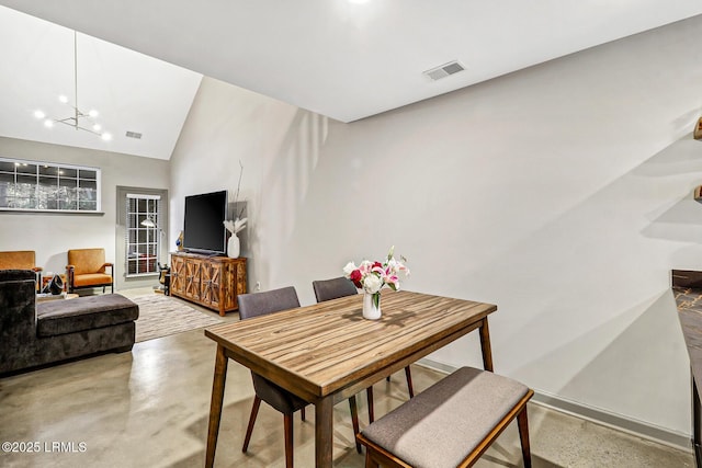 610 E Ave, Bluffton, SC 29910 - dining room with visible vents, finished concrete flooring, vaulted ceiling, and a chandelier