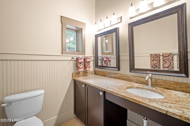 bathroom with vanity, toilet, and tile patterned flooring