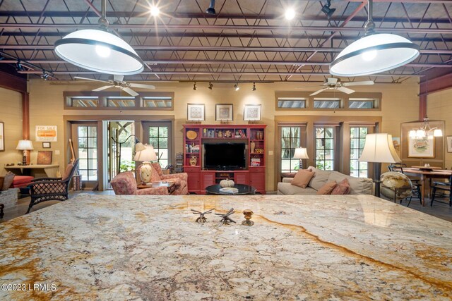 living room featuring a wealth of natural light and ceiling fan