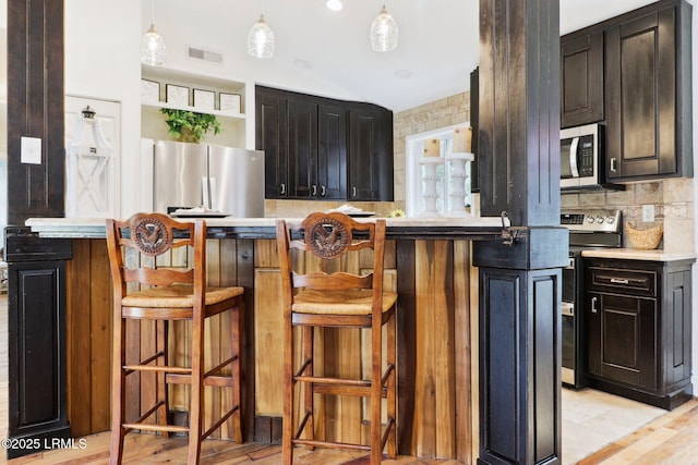 1617 Paris Ave W, Port Royal, SC 29935 - kitchen with appliances with stainless steel finishes, tasteful backsplash, and light countertops
