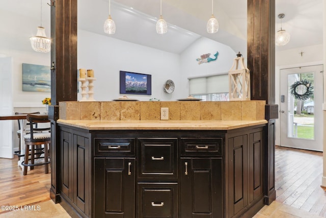 1617 Paris Ave W, Port Royal, SC 29935 - kitchen featuring vaulted ceiling, light wood-style flooring, pendant lighting, and light stone counters