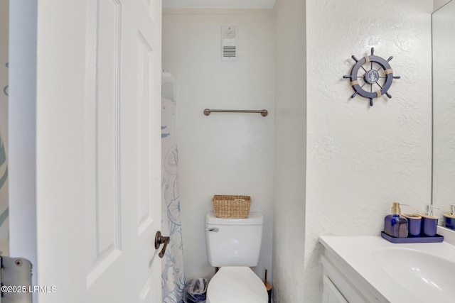 bathroom with vanity and toilet