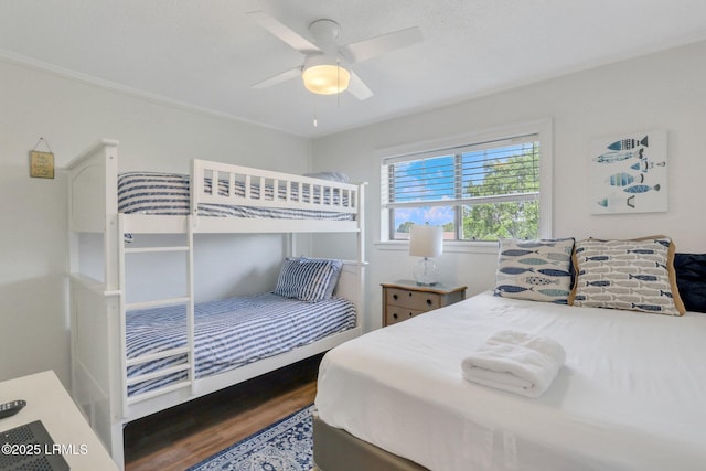 bedroom with dark hardwood / wood-style flooring and ceiling fan