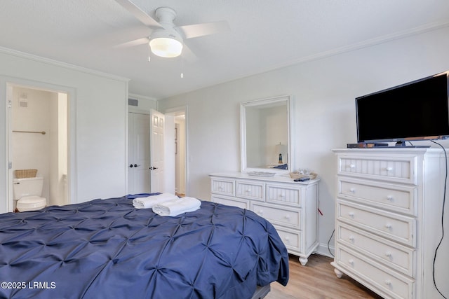 bedroom featuring ornamental molding, light wood-type flooring, connected bathroom, and ceiling fan