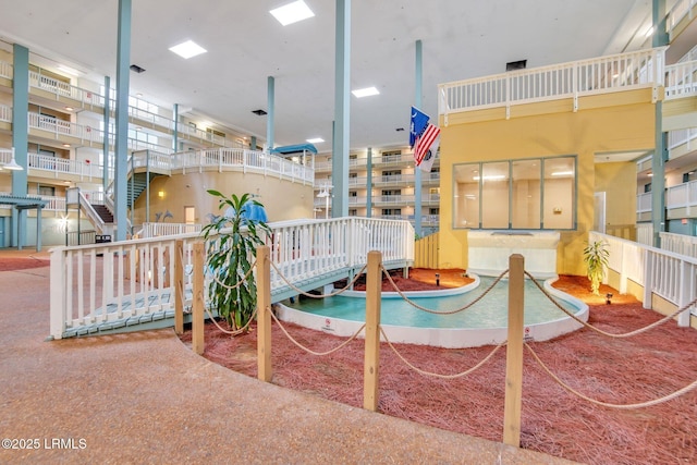 view of swimming pool featuring a hot tub