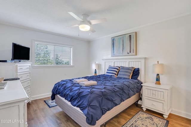 bedroom with crown molding, a textured ceiling, ceiling fan, and light hardwood / wood-style flooring