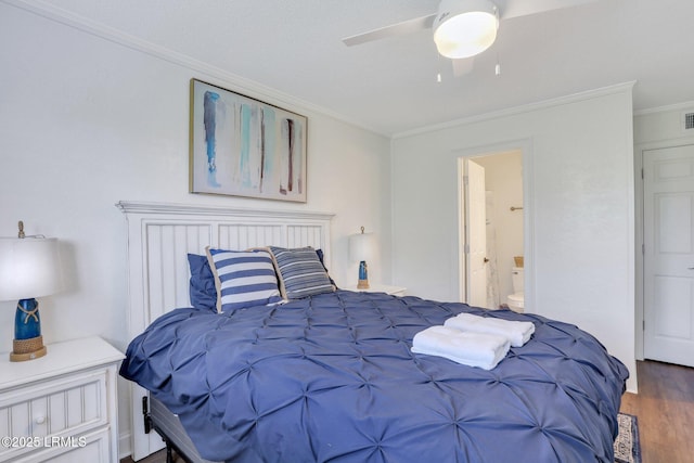 bedroom featuring hardwood / wood-style floors, ornamental molding, connected bathroom, and ceiling fan