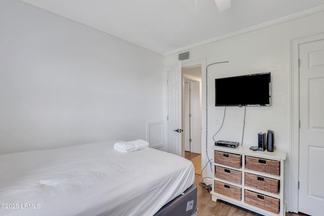 bedroom featuring hardwood / wood-style floors and ceiling fan