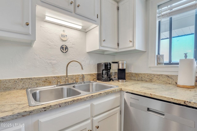 kitchen with sink, stainless steel dishwasher, and white cabinets