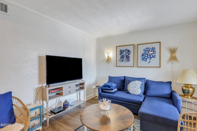 living room featuring crown molding and hardwood / wood-style floors