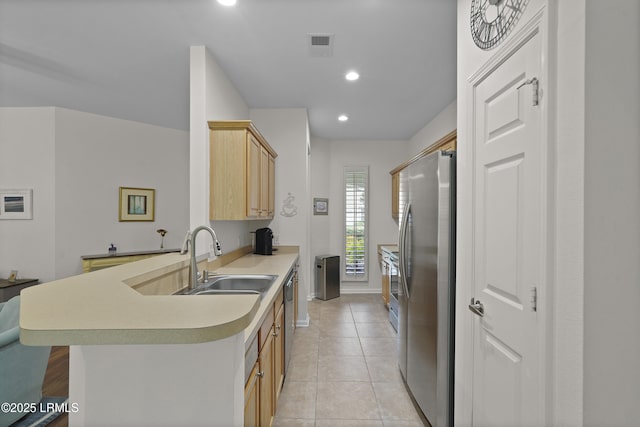 193 Landing Ln, Bluffton, SC 29909 - kitchen featuring appliances with stainless steel finishes, light brown cabinetry, light countertops, a peninsula, and light tile patterned floors