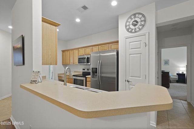 193 Landing Ln, Bluffton, SC 29909 - kitchen with stainless steel appliances, recessed lighting, light countertops, a peninsula, and light tile patterned floors