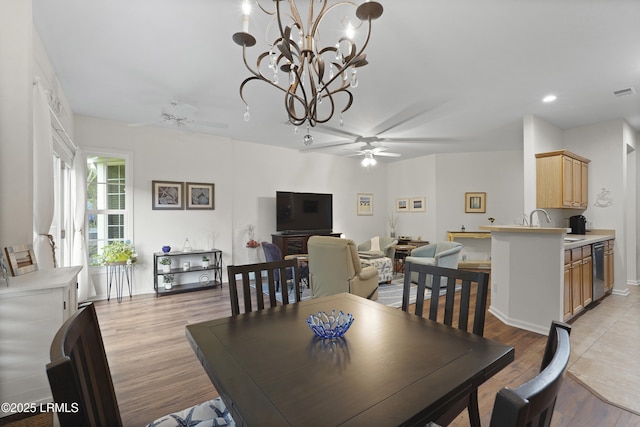193 Landing Ln, Bluffton, SC 29909 - dining area with ceiling fan, light wood finished floors, a chandelier, and recessed lighting