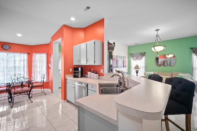50 Padgett Dr, Bluffton, SC 29909 - kitchen with a peninsula, visible vents, dishwasher, a sink, and light countertops