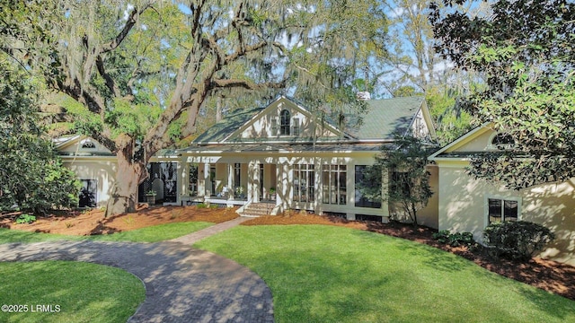 14 Ghost Pony Rd, Bluffton, SC 29910 - tudor home featuring covered porch, a front yard, and stucco siding