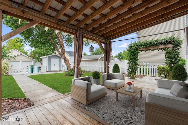 wooden terrace featuring a shed, an outdoor living space, and a lawn