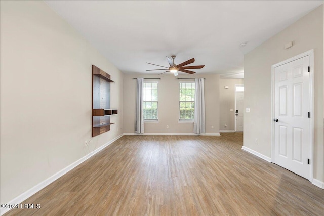 spare room featuring ceiling fan and light hardwood / wood-style flooring