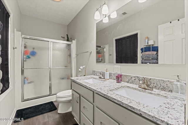bathroom featuring a shower stall and a sink